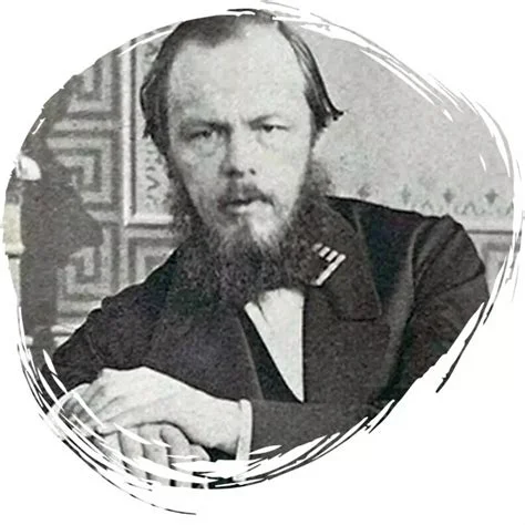 A black-and-white portrait photograph of a bearded middle-aged man in a dark coat, seated with arms folded, presented in a circular vignette frame.